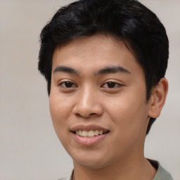 Joyful asian young-adult male with short  black hair and brown eyes