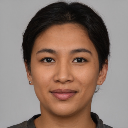 Joyful asian young-adult female with short  brown hair and brown eyes