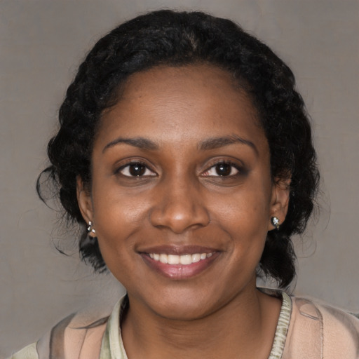 Joyful black young-adult female with medium  black hair and brown eyes