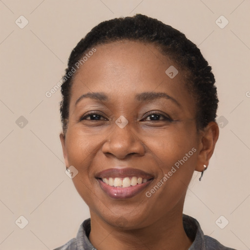 Joyful black adult female with short  brown hair and brown eyes