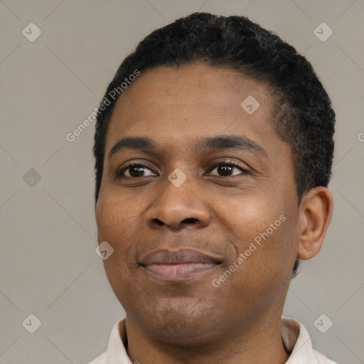 Joyful black young-adult male with short  black hair and brown eyes