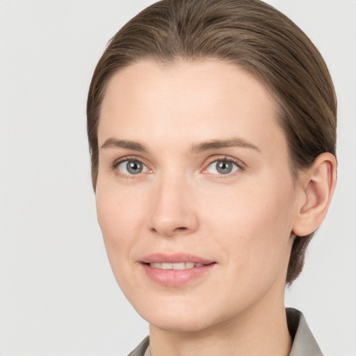 Joyful white young-adult female with medium  brown hair and grey eyes