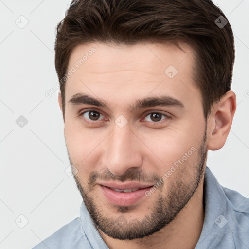 Joyful white young-adult male with short  brown hair and brown eyes