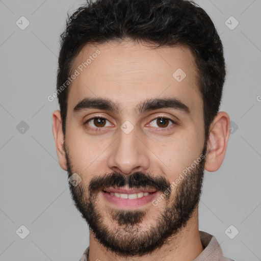 Joyful white young-adult male with short  black hair and brown eyes