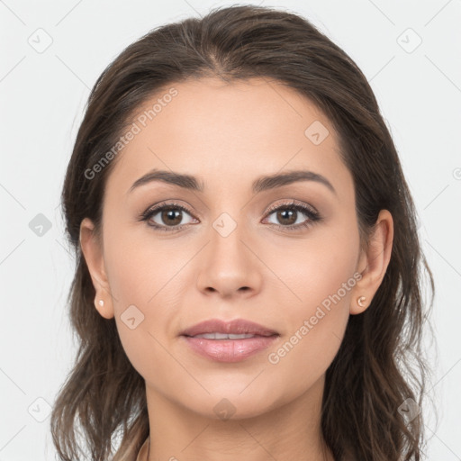 Joyful white young-adult female with long  brown hair and brown eyes