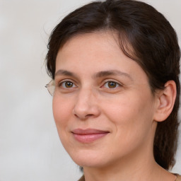 Joyful white adult female with medium  brown hair and brown eyes