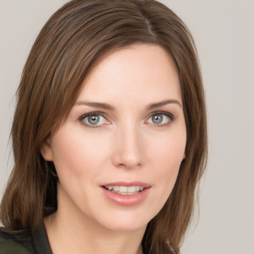 Joyful white young-adult female with medium  brown hair and green eyes