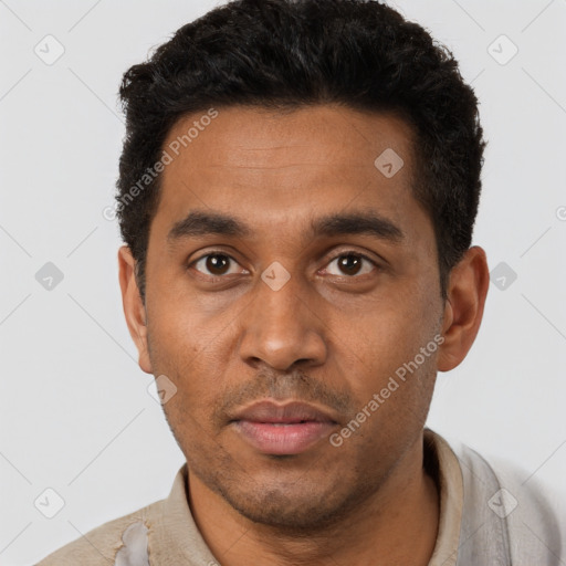 Joyful black young-adult male with short  black hair and brown eyes