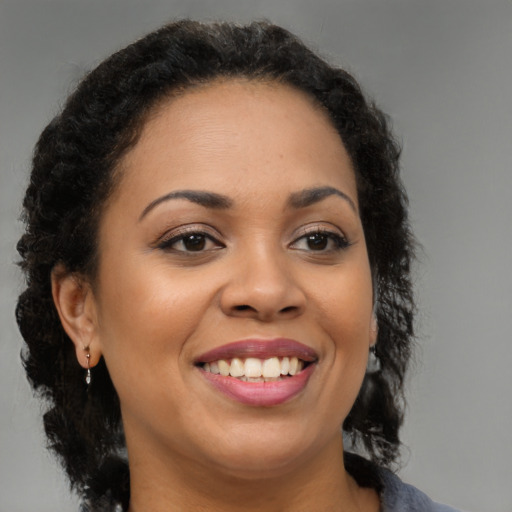 Joyful black young-adult female with medium  brown hair and brown eyes