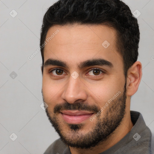 Joyful white young-adult male with short  black hair and brown eyes