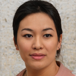 Joyful asian young-adult female with short  brown hair and brown eyes