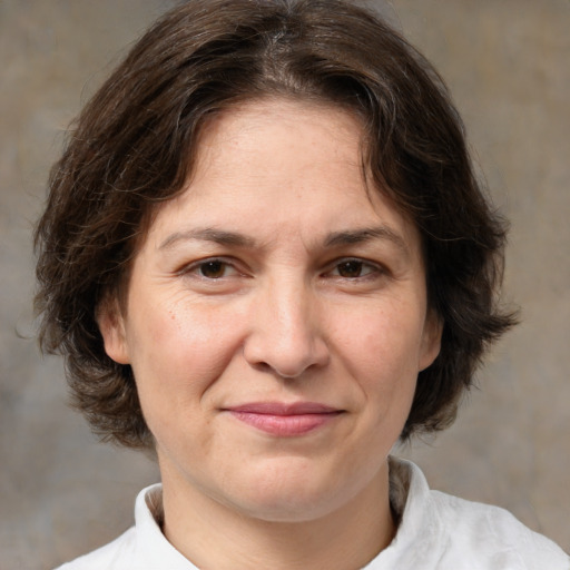 Joyful white adult female with medium  brown hair and brown eyes