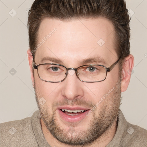 Joyful white adult male with short  brown hair and grey eyes