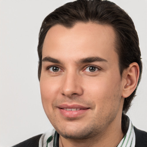 Joyful white young-adult male with short  brown hair and brown eyes