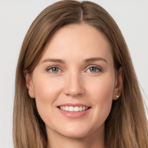 Joyful white young-adult female with long  brown hair and grey eyes