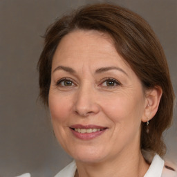 Joyful white adult female with medium  brown hair and brown eyes