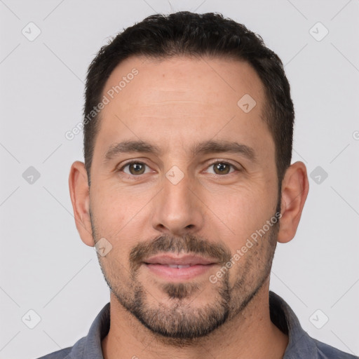 Joyful white young-adult male with short  black hair and brown eyes