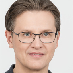 Joyful white adult male with short  brown hair and grey eyes