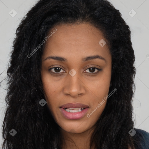 Joyful black young-adult female with long  black hair and brown eyes