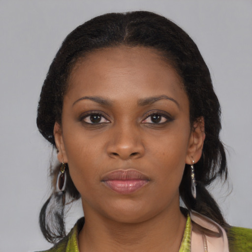 Neutral black young-adult female with medium  brown hair and brown eyes