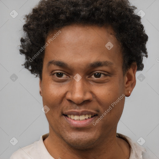 Joyful black young-adult male with short  brown hair and brown eyes