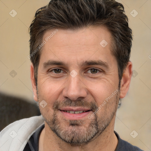 Joyful white adult male with short  brown hair and brown eyes