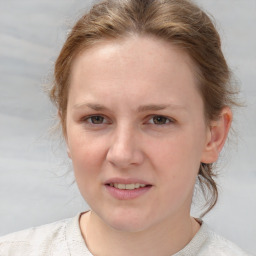 Joyful white young-adult female with medium  brown hair and blue eyes