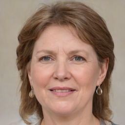 Joyful white adult female with medium  brown hair and blue eyes