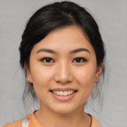 Joyful asian young-adult female with medium  brown hair and brown eyes