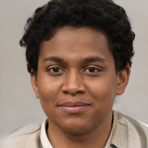 Joyful black young-adult male with short  brown hair and brown eyes