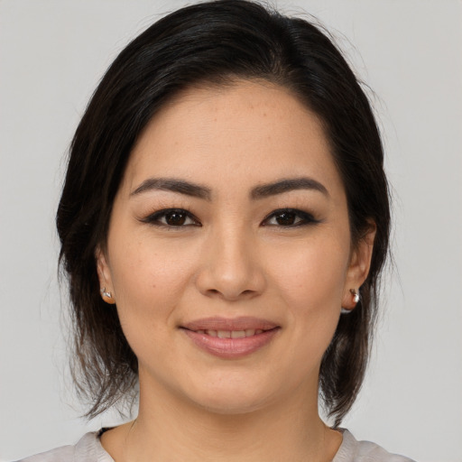 Joyful white young-adult female with medium  brown hair and brown eyes
