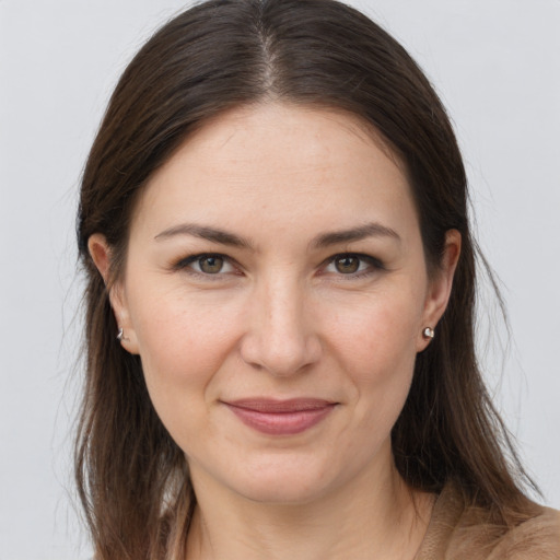 Joyful white young-adult female with long  brown hair and grey eyes