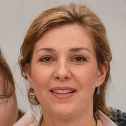 Joyful white adult female with medium  brown hair and grey eyes