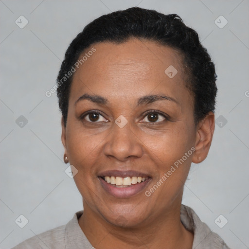 Joyful latino adult female with short  black hair and brown eyes