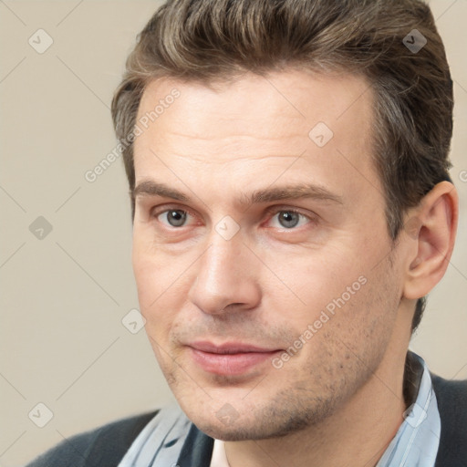 Joyful white adult male with short  brown hair and brown eyes