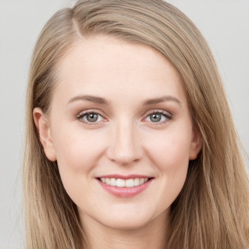 Joyful white young-adult female with long  brown hair and grey eyes