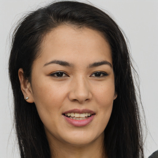 Joyful latino young-adult female with long  brown hair and brown eyes