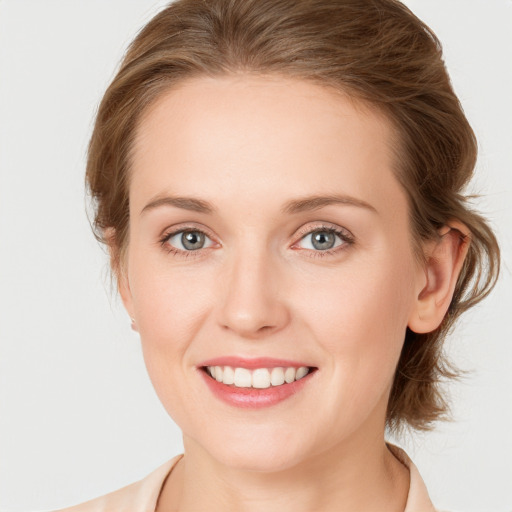 Joyful white young-adult female with medium  brown hair and blue eyes