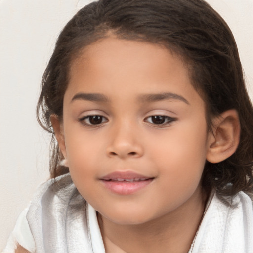 Joyful latino child female with medium  brown hair and brown eyes