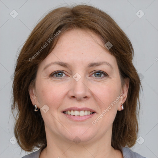 Joyful white adult female with medium  brown hair and grey eyes