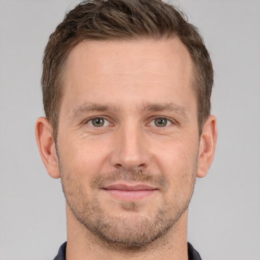 Joyful white adult male with short  brown hair and brown eyes