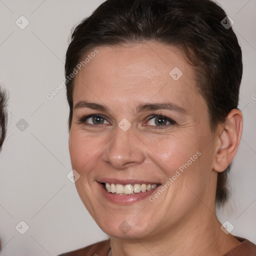 Joyful white adult female with medium  brown hair and brown eyes