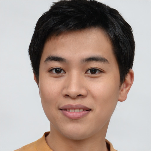 Joyful asian young-adult male with short  black hair and brown eyes