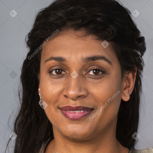 Joyful black young-adult female with long  brown hair and brown eyes