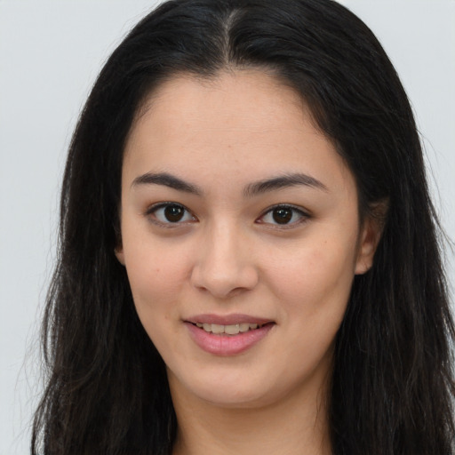 Joyful asian young-adult female with long  brown hair and brown eyes