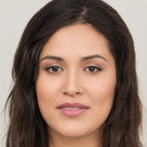 Joyful white young-adult female with long  brown hair and brown eyes