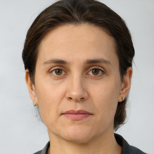 Joyful white adult female with medium  brown hair and grey eyes