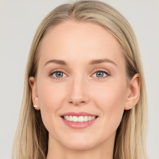 Joyful white young-adult female with long  brown hair and blue eyes