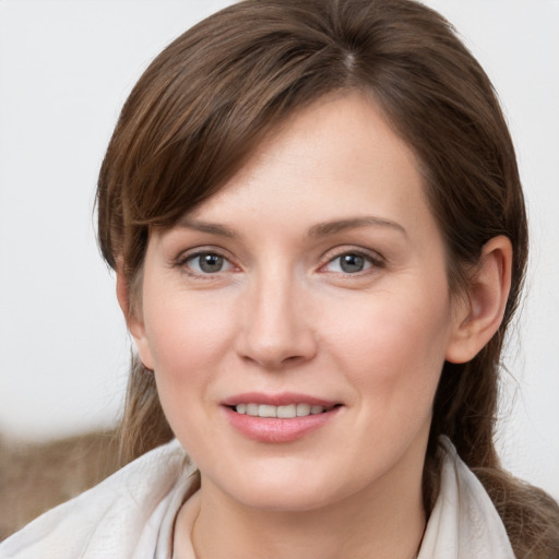 Joyful white young-adult female with medium  brown hair and grey eyes