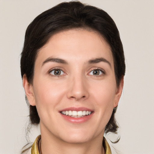 Joyful white young-adult female with medium  brown hair and brown eyes